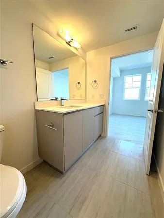 a room with a sink and a mirror