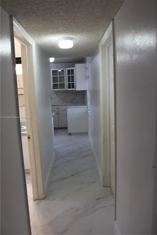 a view of a kitchen with a sink and cabinets