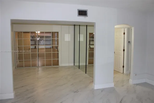 an empty room with windows and closet