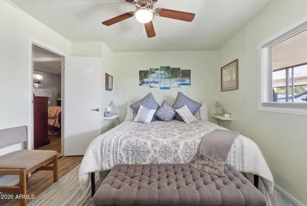 a bedroom with a bed and a large window