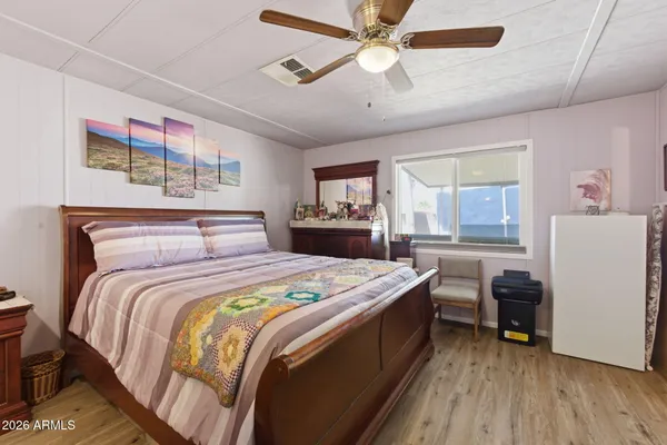 a bedroom with a bed and a large mirror on the wall