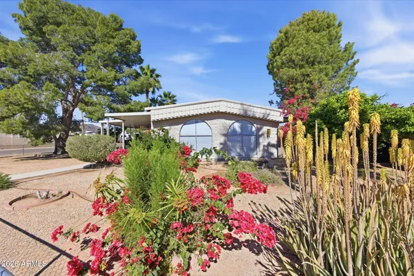a view of a house with backyard and sitting area