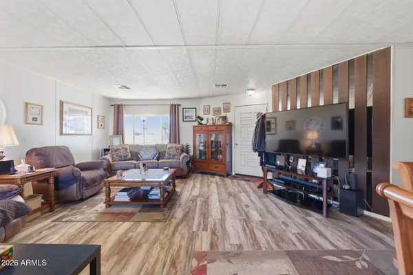 a living room with furniture and wooden floor