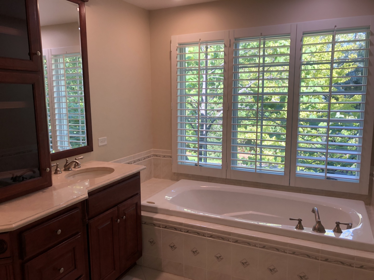1021 Old Mill Road Lake Forest, IL 60045 - Photo 9 of 13 a bathroom with a double vanity sink window and two mirror