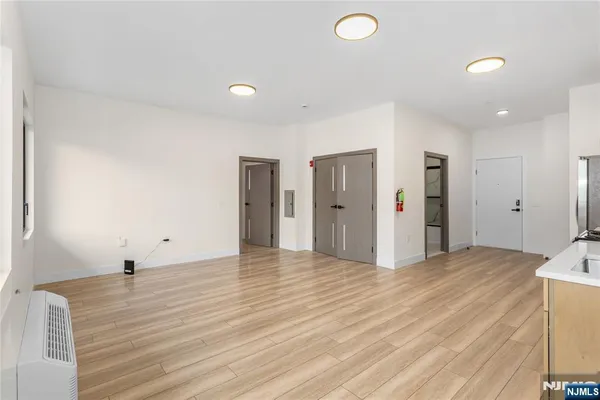 a view of empty room with wooden floor