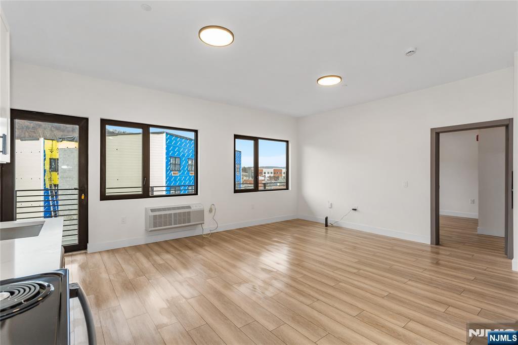 89 Mary Street, Unit 502 Paterson, NJ 07503 - Photo 8 of 13 wooden floor in an empty room with a window