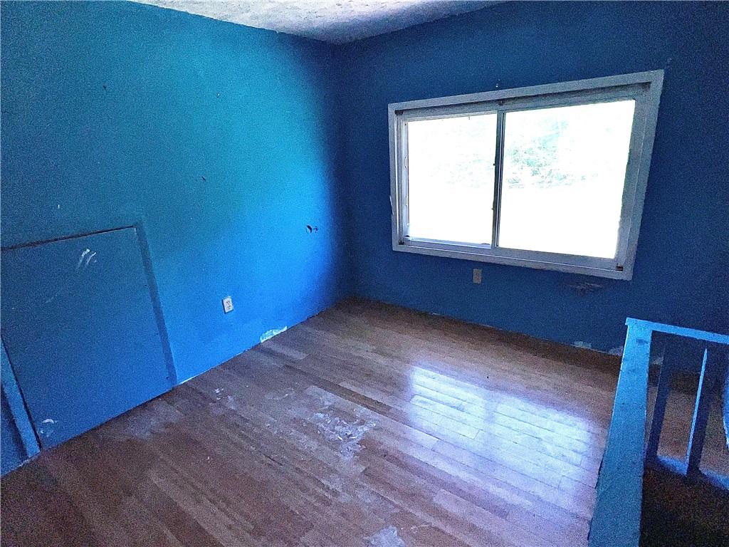 151 Oak Forest Road Brave, PA 15316 - Photo 12 of 16 a view of empty room with wooden floor and fan