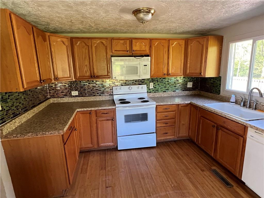 151 Oak Forest Road Brave, PA 15316 - Photo 2 of 16 a kitchen with a stove a sink and a granite counter tops