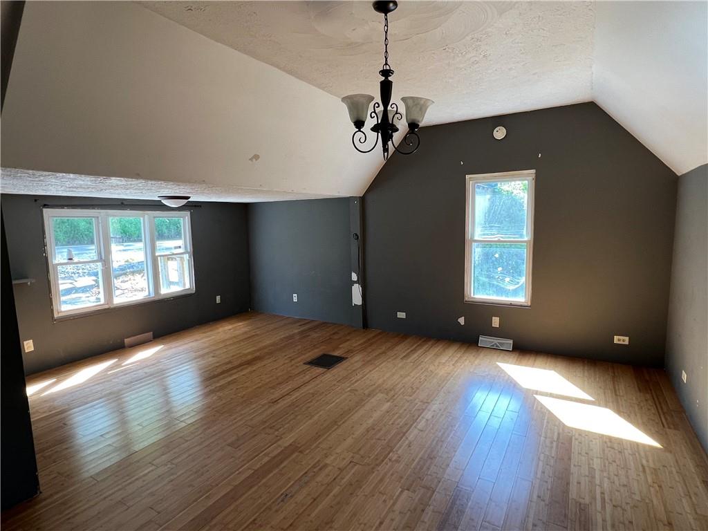 151 Oak Forest Road Brave, PA 15316 - Photo 5 of 16 a view of an empty room with a window and wooden floor