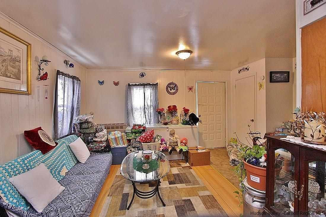 779 Neighborhood Road Lake Katrine, NY 12449 - Photo 16 of 26 a living room with furniture and a large mirror
