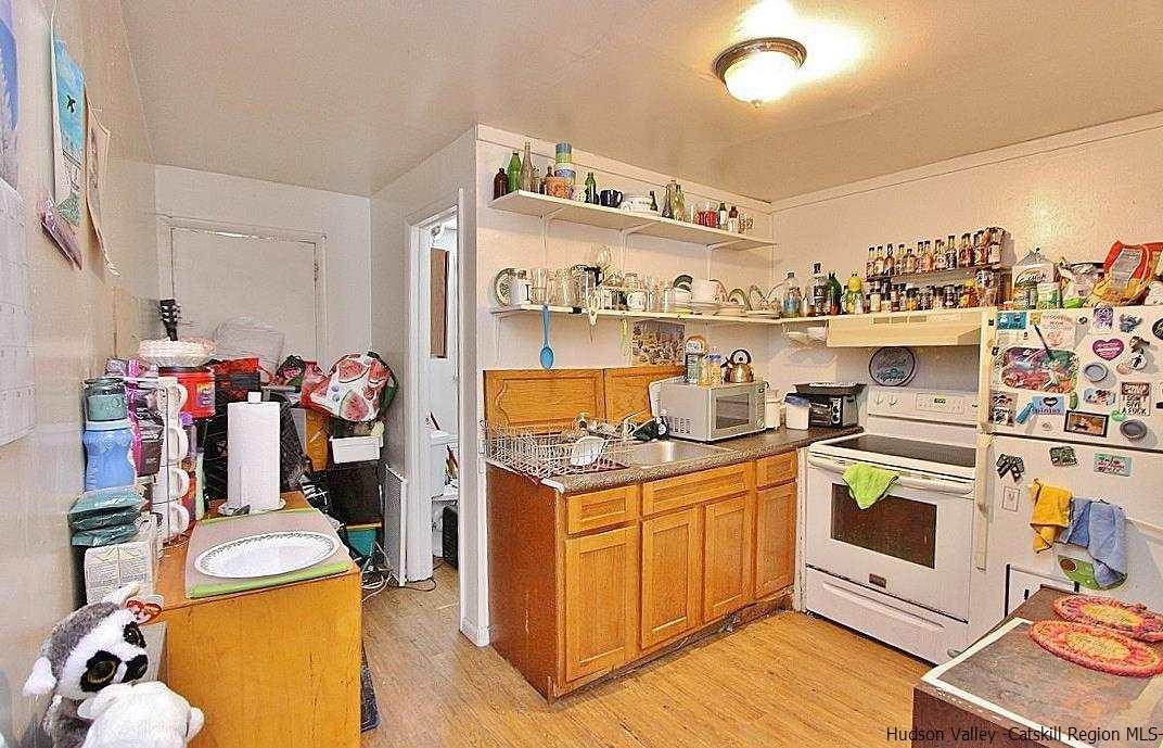 779 Neighborhood Road Lake Katrine, NY 12449 - Photo 2 of 26 a kitchen with a stove and wooden cabinets