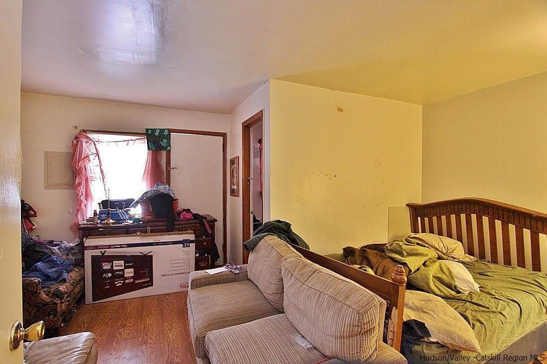 779 Neighborhood Road Lake Katrine, NY 12449 - Photo 8 of 26 a bedroom with a bed and wooden floor