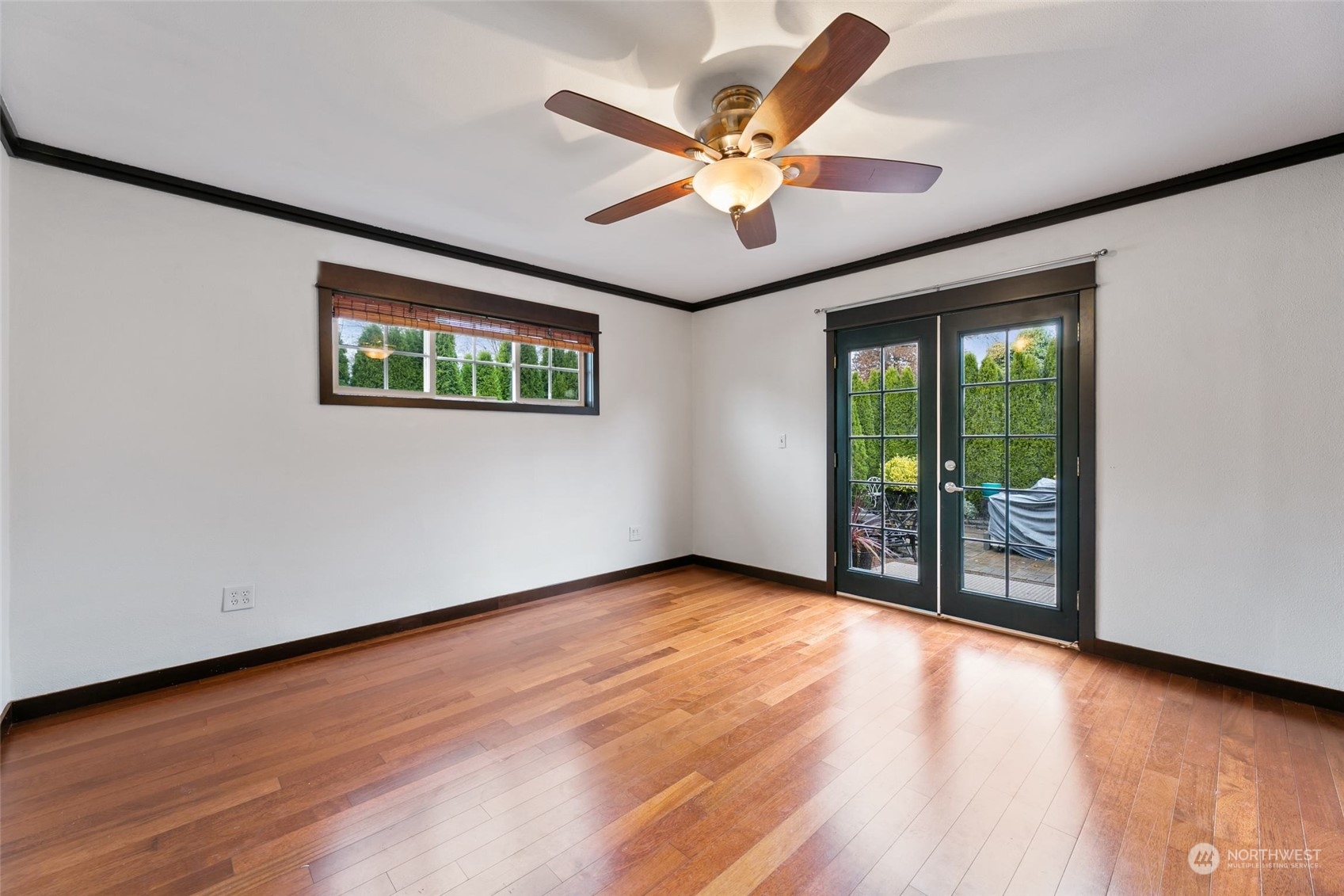 708 North 5th Street Renton, WA 98057 - Photo 13 of 29 an empty room with wooden floor and windows