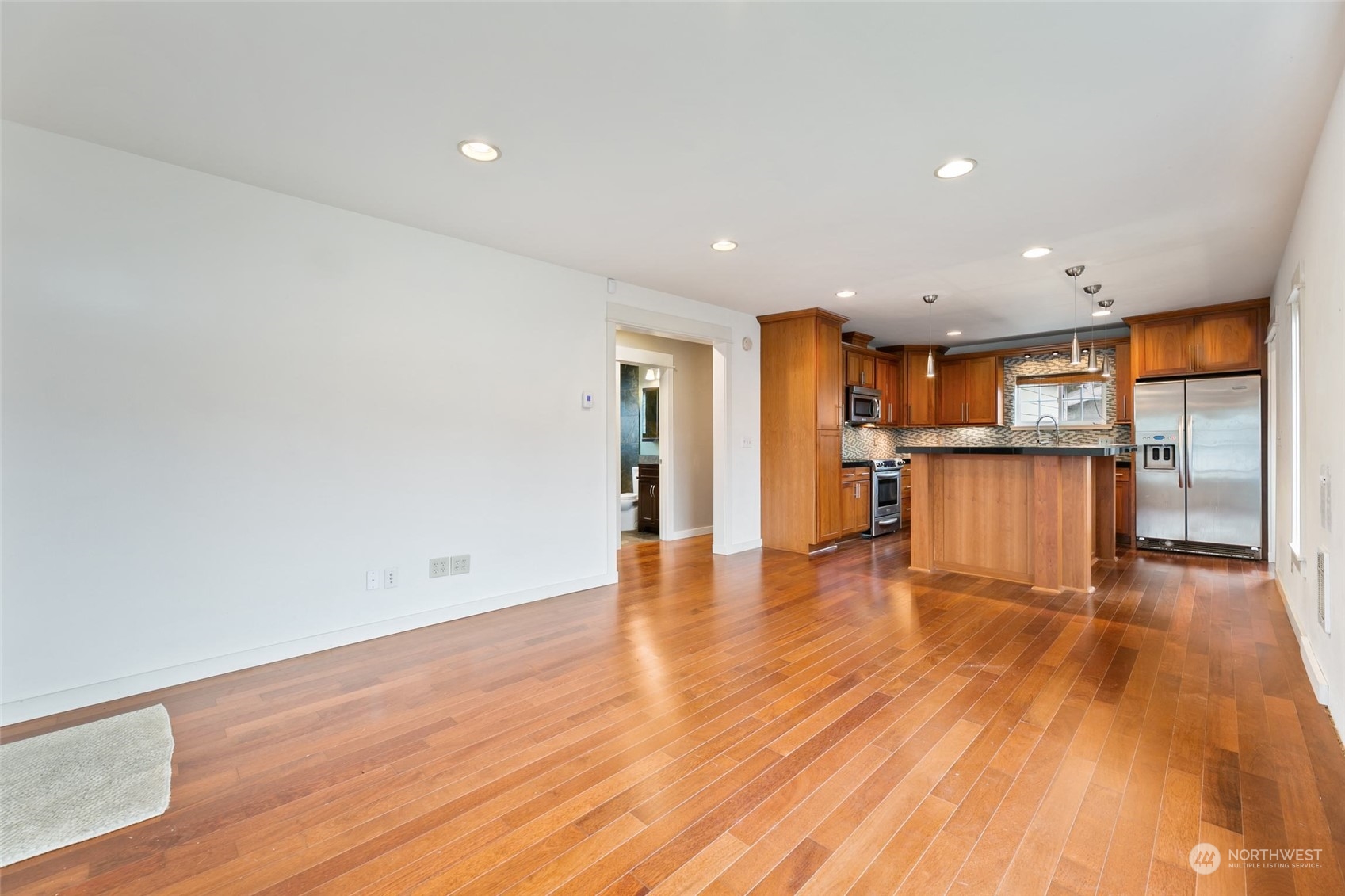 708 North 5th Street Renton, WA 98057 - Photo 2 of 29 a view of a kitchen with a wooden floor and a kitchen