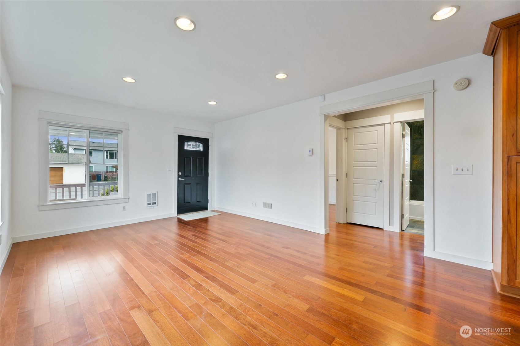 708 North 5th Street Renton, WA 98057 - Photo 8 of 29 a view of an empty room with wooden floor and a window