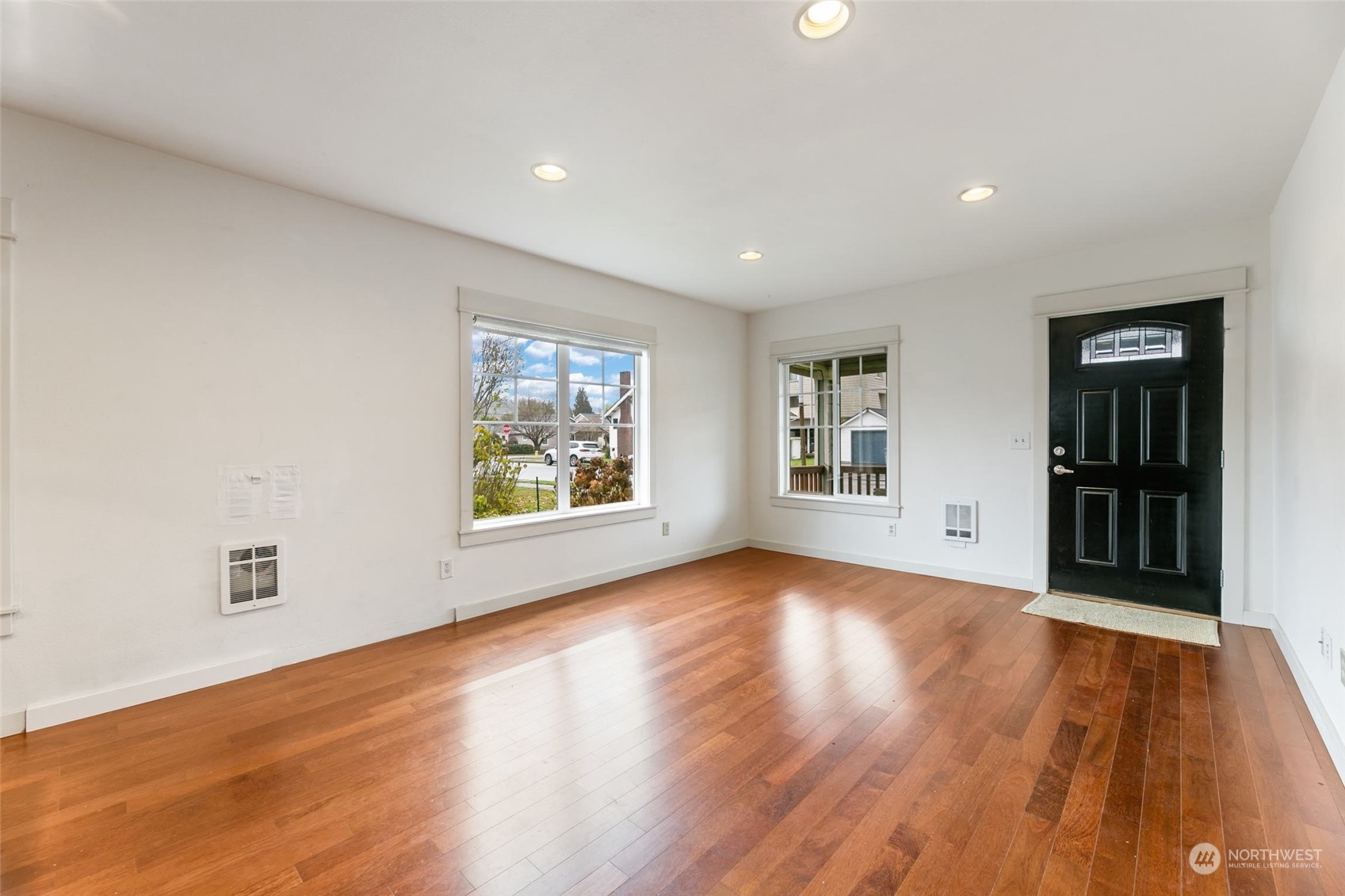 708 North 5th Street Renton, WA 98057 - Photo 9 of 29 an empty room with wooden floor and windows