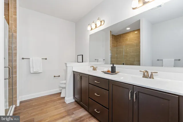 a bathroom with a double vanity sink mirror and double