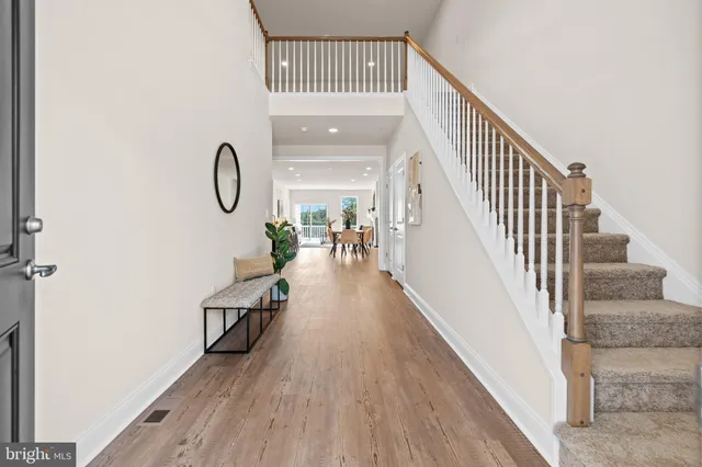 a view of entryway and hall with wooden floor