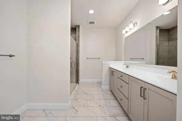 a spacious bathroom with a double vanity sink and a mirror