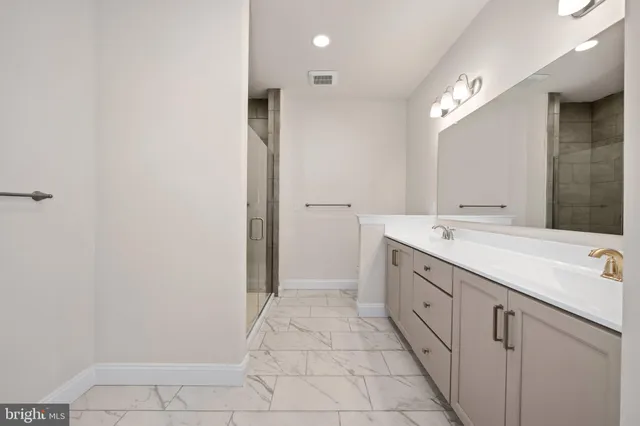 a spacious bathroom with a double vanity sink and a mirror