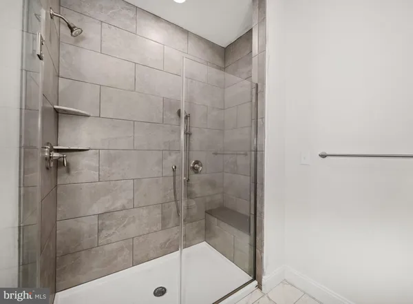 a bathroom with a shower and a sink