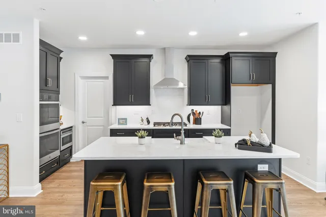 a kitchen with granite countertop a sink and refrigerator