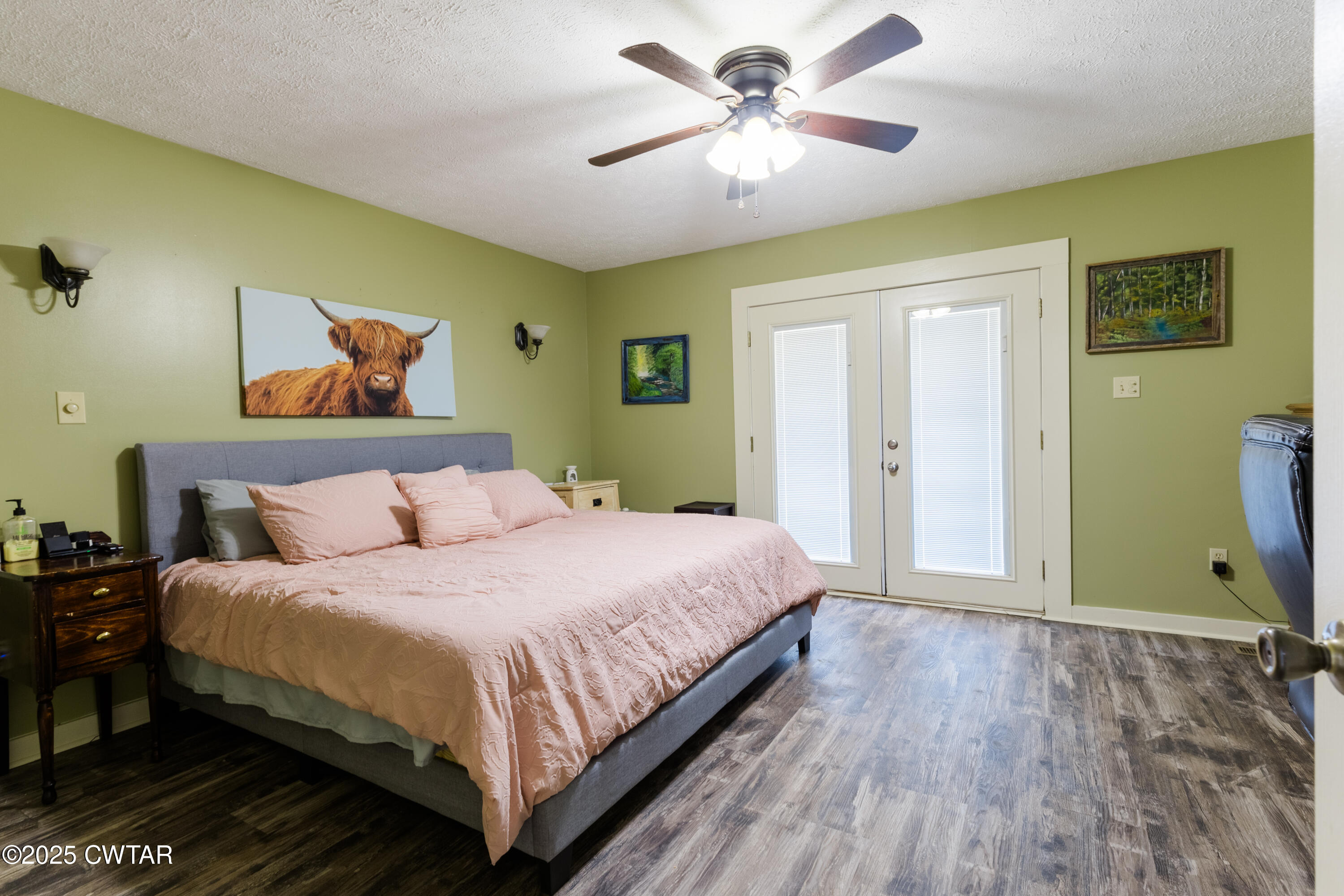 47 Peace Chapel Road Scotts Hill, TN 38374 - Photo 11 of 28 a bedroom with a bed and a chandelier