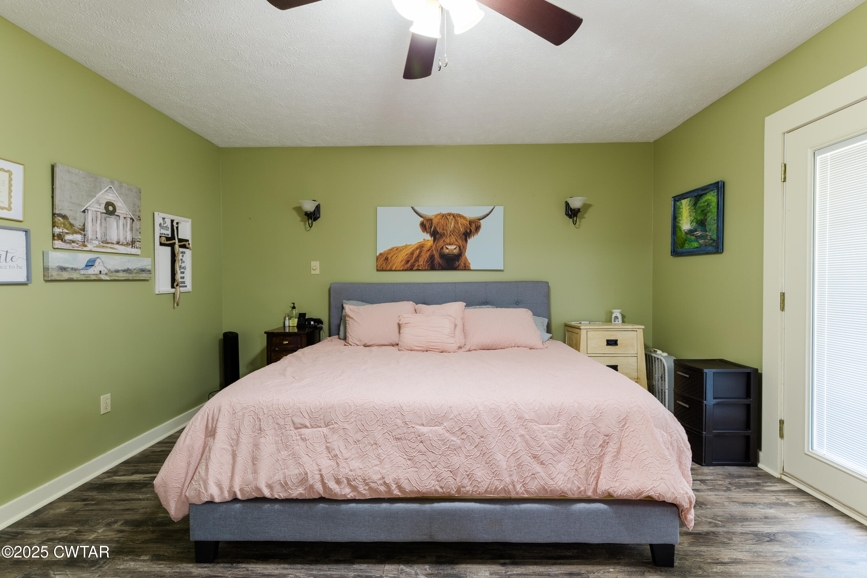 47 Peace Chapel Road Scotts Hill, TN 38374 - Photo 12 of 28 a bedroom with a bed and a chandelier