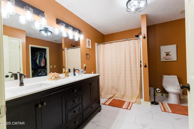 a bathroom with a double vanity sink mirror and shower