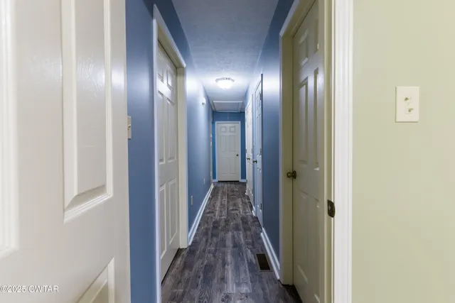 a view of hallway with wooden floor