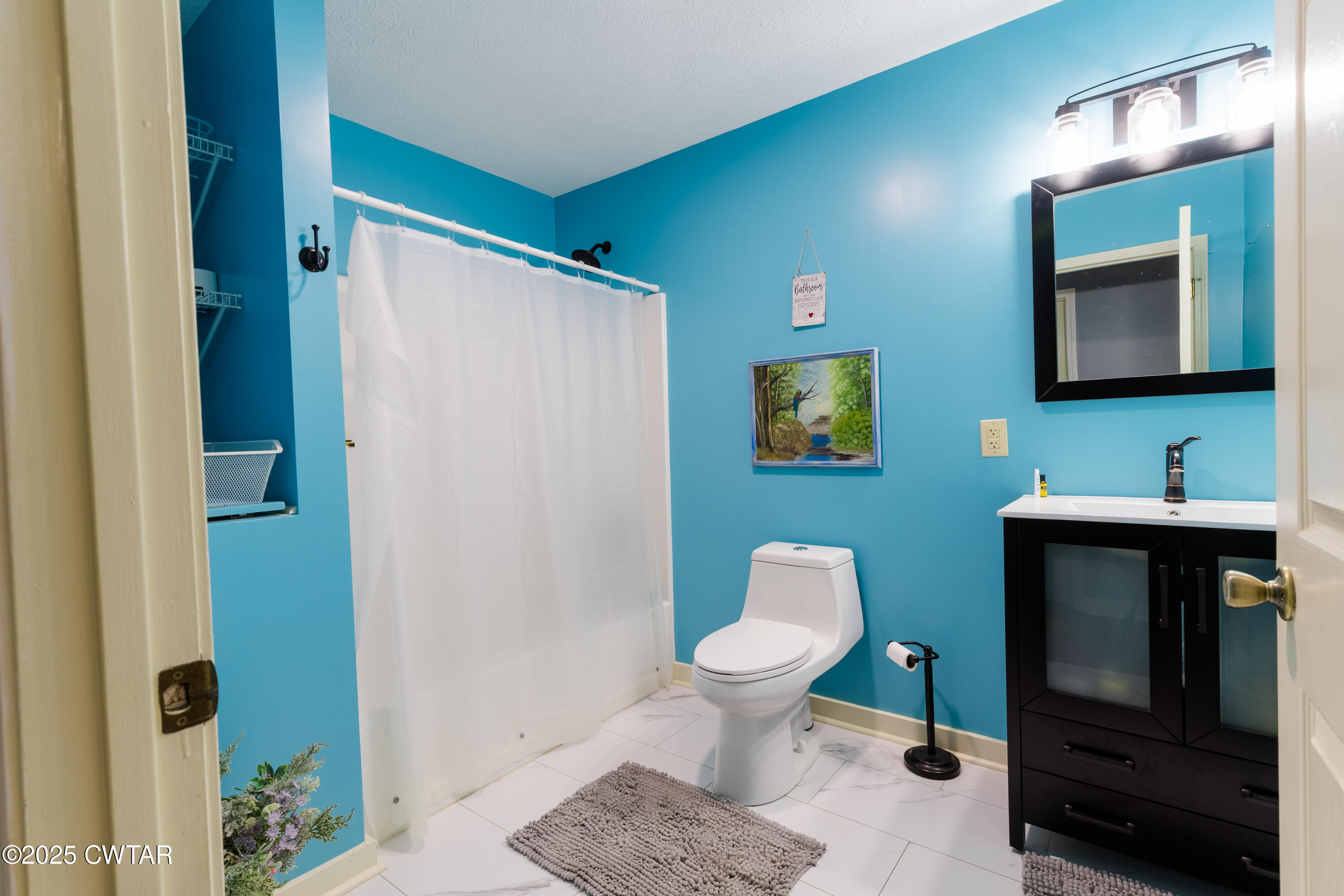 47 Peace Chapel Road Scotts Hill, TN 38374 - Photo 19 of 28 a bathroom with a toilet sink and mirror