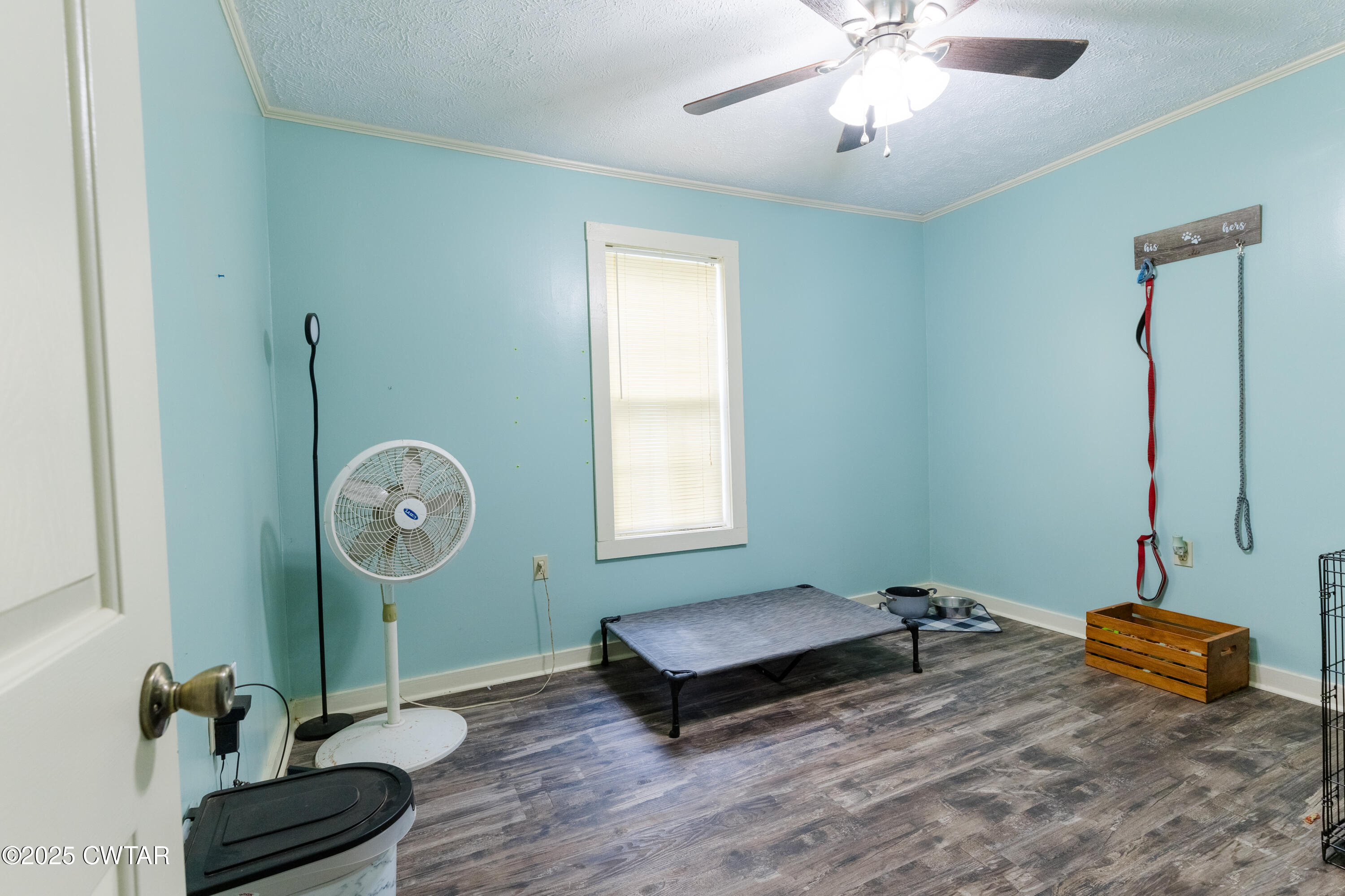 47 Peace Chapel Road Scotts Hill, TN 38374 - Photo 21 of 28 a living room with hard wood flooring and a chandelier