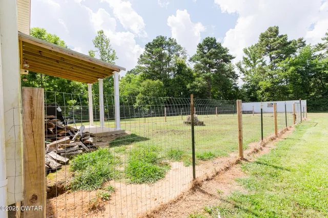 a view of a backyard with sitting area