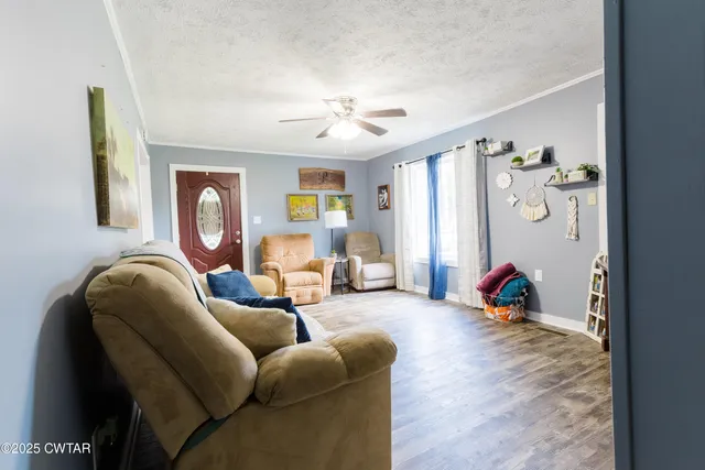 a living room with furniture chess board and a window