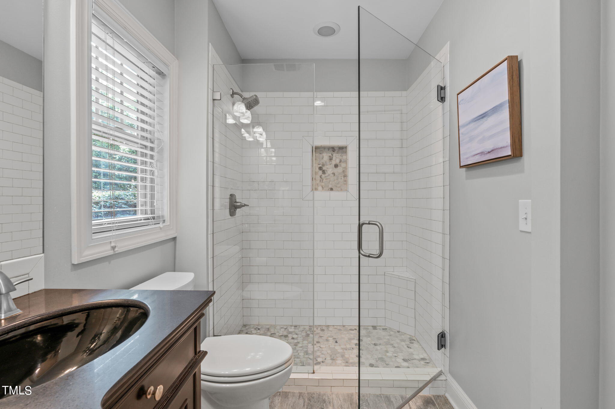 2006 McCarthy Street Raleigh, NC 27608 - Photo 24 of 40 a bathroom with a sink a toilet and shower