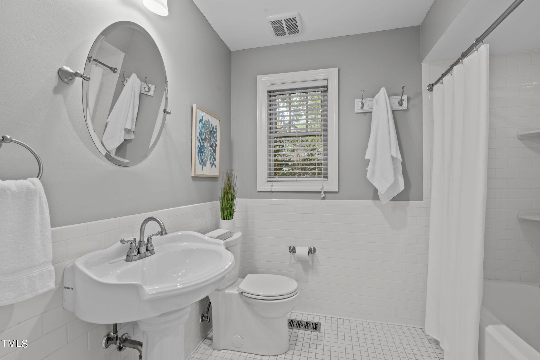 2006 McCarthy Street Raleigh, NC 27608 - Photo 28 of 40 a bathroom with a sink a toilet and a mirror