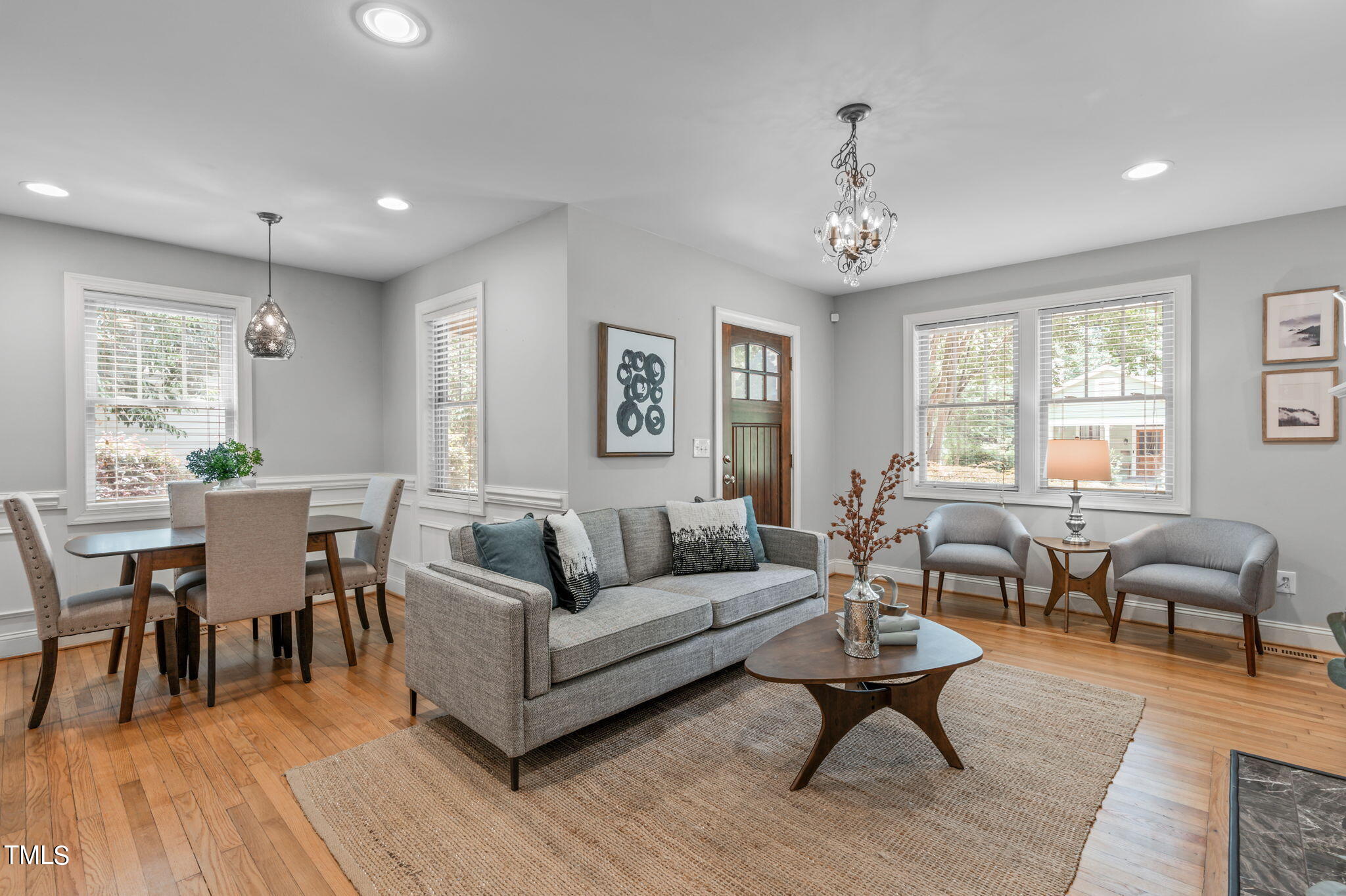 2006 McCarthy Street Raleigh, NC 27608 - Photo 10 of 40 a living room with furniture two window and a wooden floor