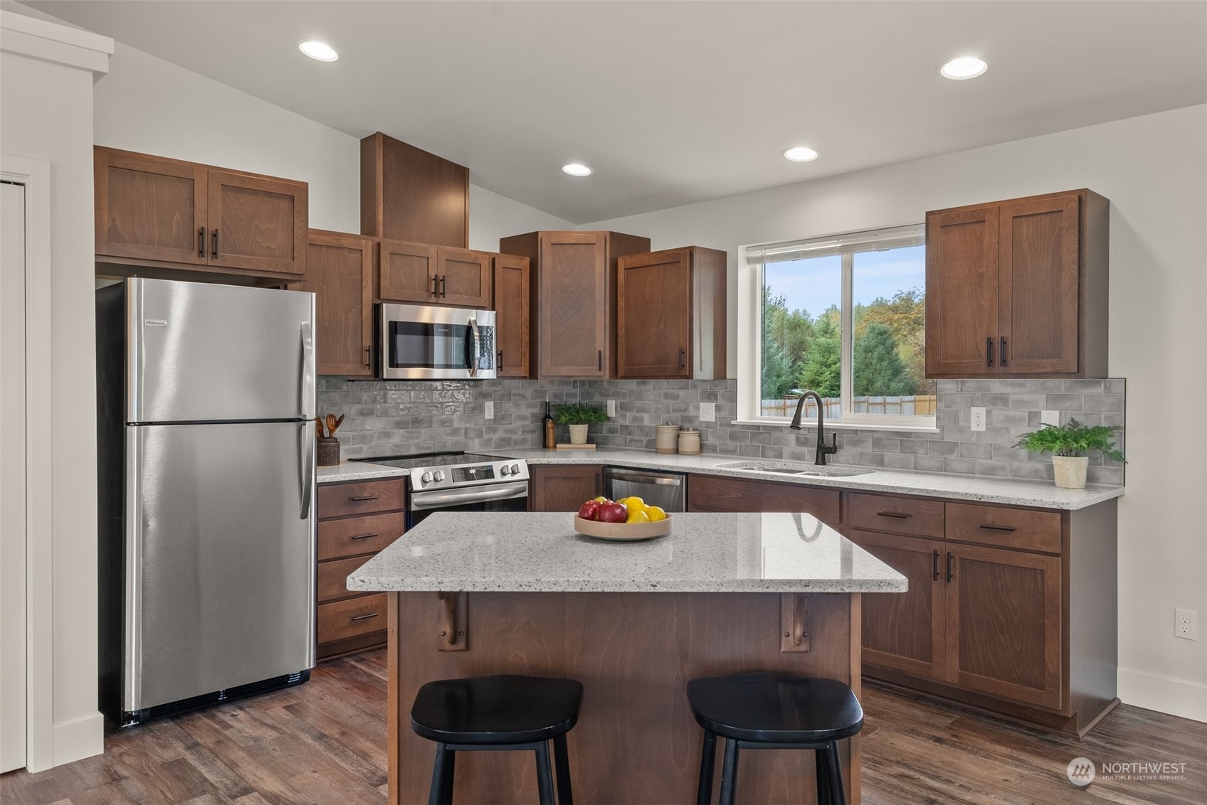 379-14 Collins Road Toledo, WA 98591 - Photo 6 of 30 a kitchen with stainless steel appliances a refrigerator a sink a stove a dining table and chairs