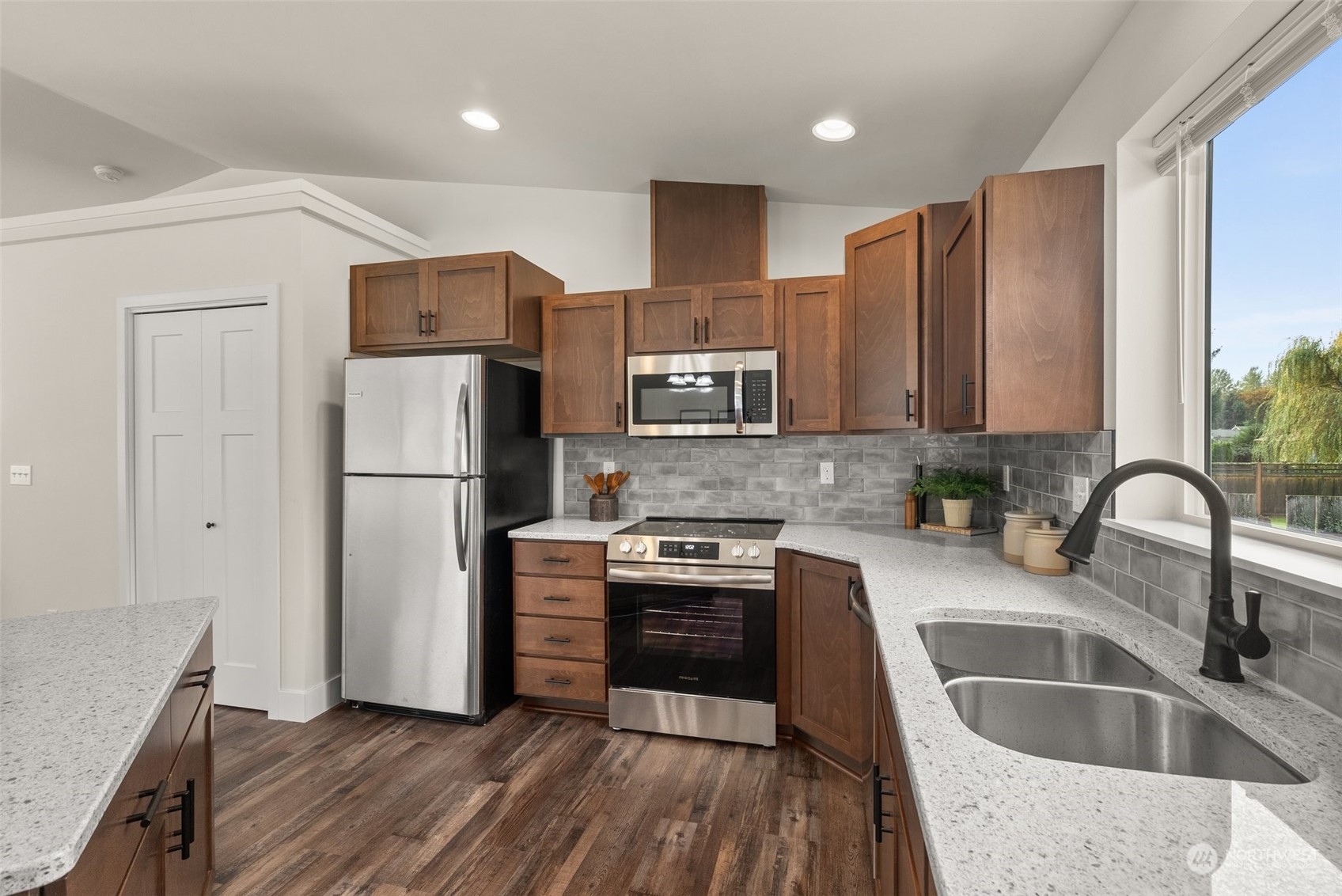 379-14 Collins Road Toledo, WA 98591 - Photo 7 of 30 a kitchen with kitchen island granite countertop a sink appliances and cabinets