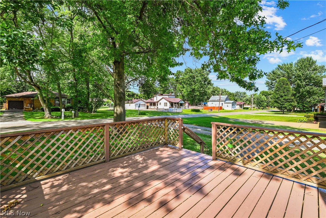 1286 Deforest Road Southeast Warren, OH 44484 - Photo 3 of 27 Exterior wood deck featuring lattice railing and a wood-finish floor