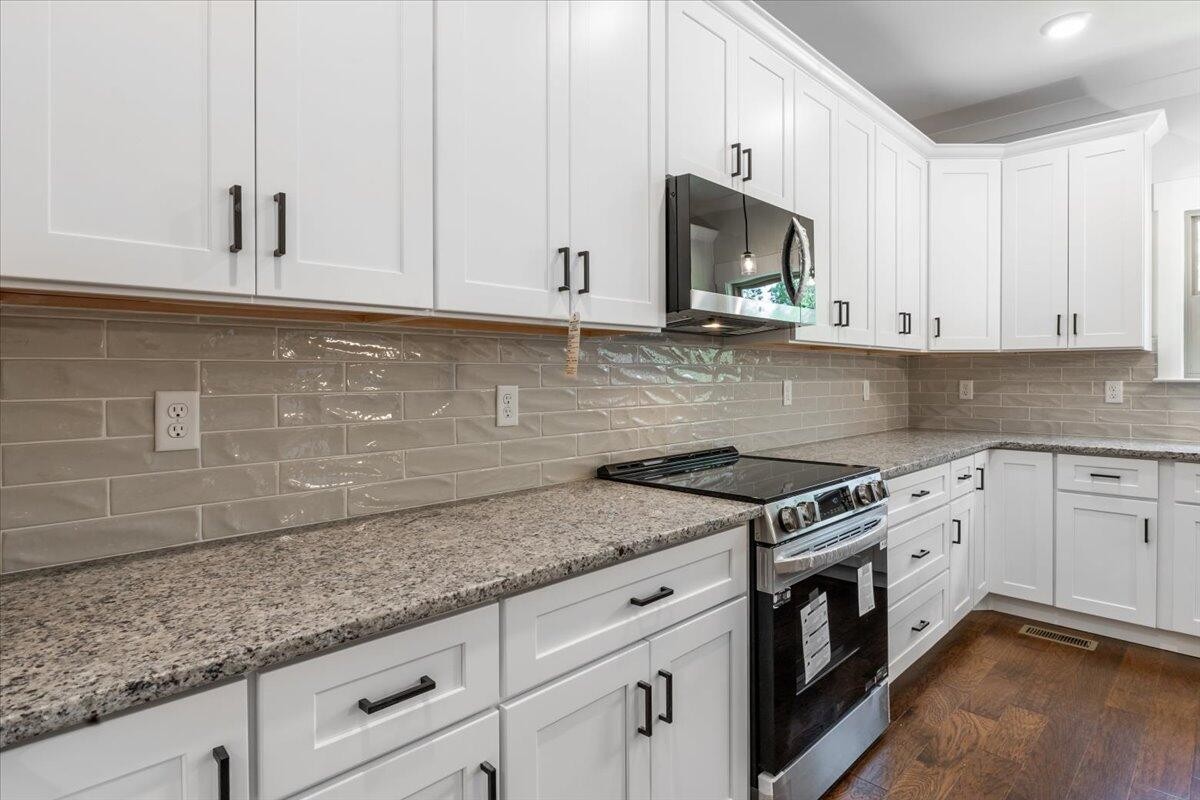 7391 Gamble Road Georgetown, TN 37336 - Photo 12 of 27 a kitchen with granite countertop white cabinets and white appliances
