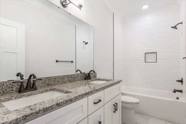 an empty room with wooden floor chandelier fan and windows