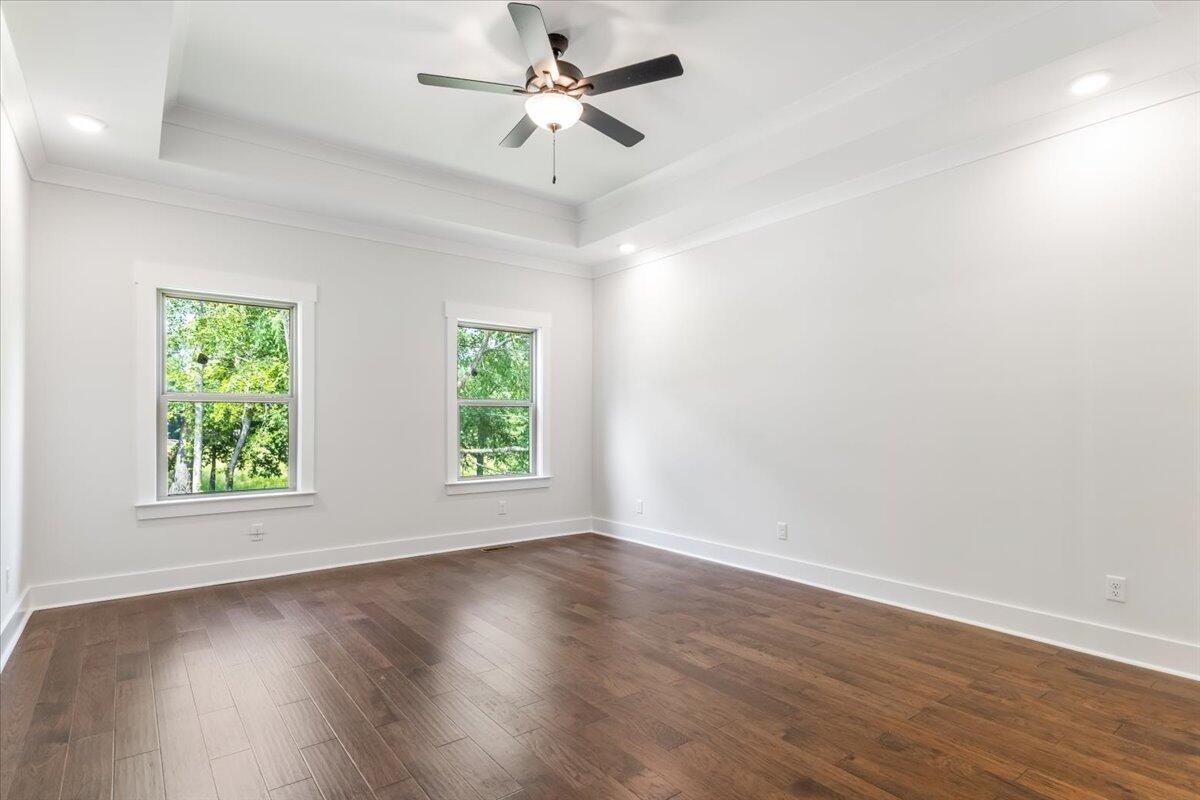 7391 Gamble Road Georgetown, TN 37336 - Photo 19 of 27 an empty room with wooden floor fan and windows