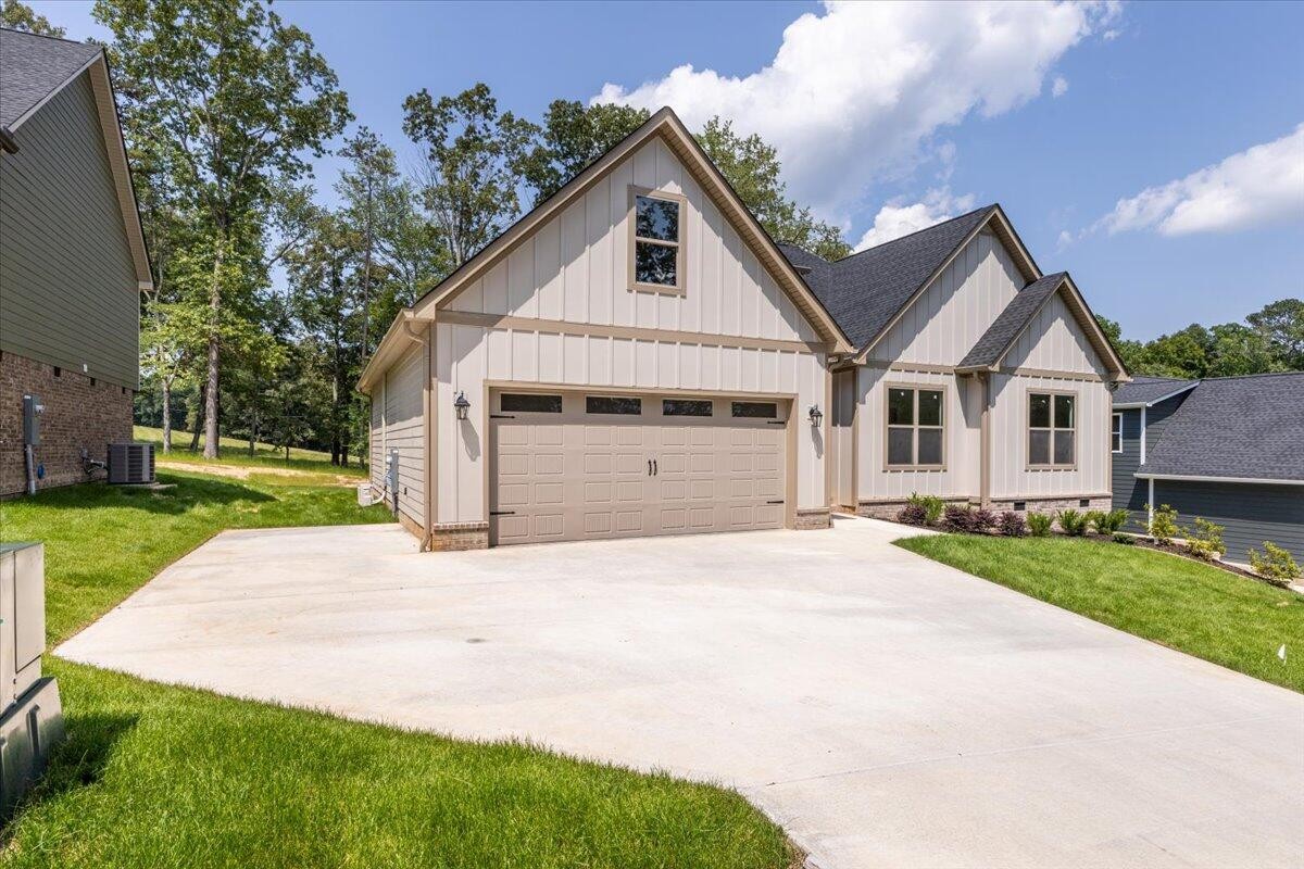7391 Gamble Road Georgetown, TN 37336 - Photo 2 of 27 a front view of a house with a yard and garage