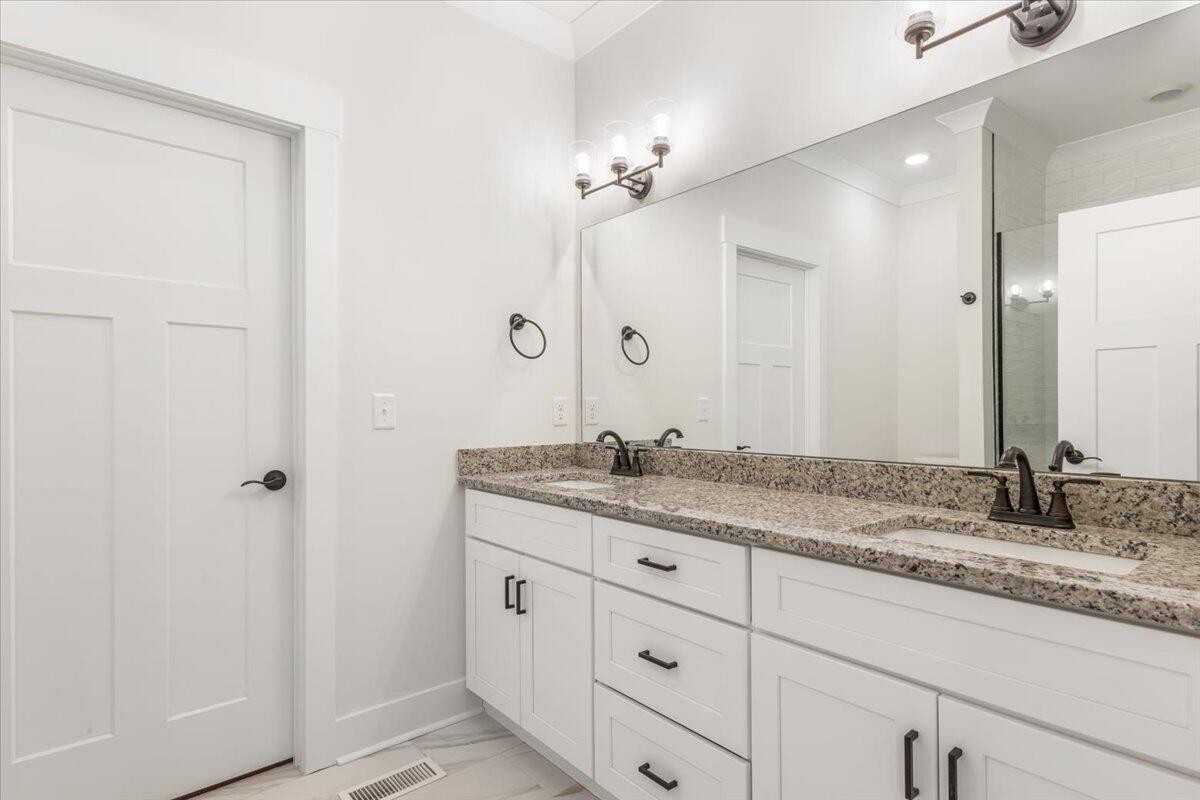 7391 Gamble Road Georgetown, TN 37336 - Photo 21 of 27 a bathroom with a granite countertop sink double and mirror