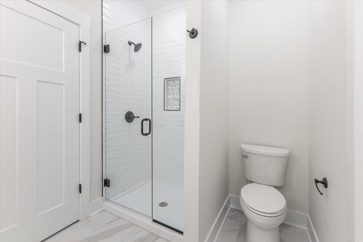 7391 Gamble Road Georgetown, TN 37336 - Photo 22 of 27 a a bathroom with a toilet and a shower