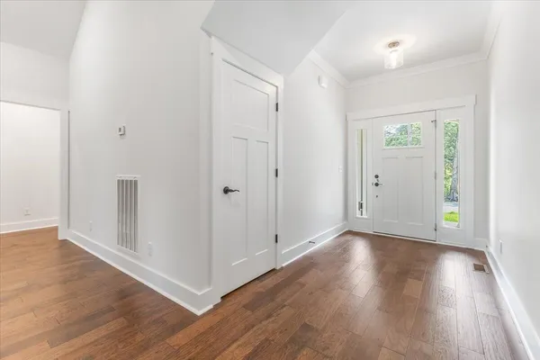 a view of a hallway with wooden floor