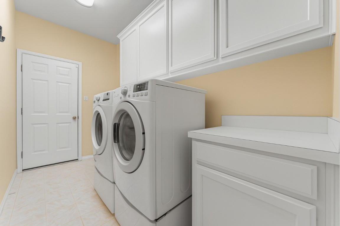 603 Flamingo Boulevard Lakeway, TX 78734 - Photo 12 of 40 The laundry room is large and has room for a freezer. Notice the area to fold your laundry and great storage too.