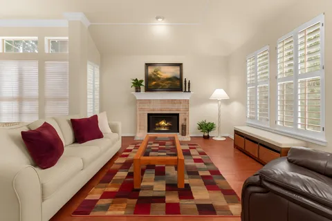 a living room with furniture and a fireplace