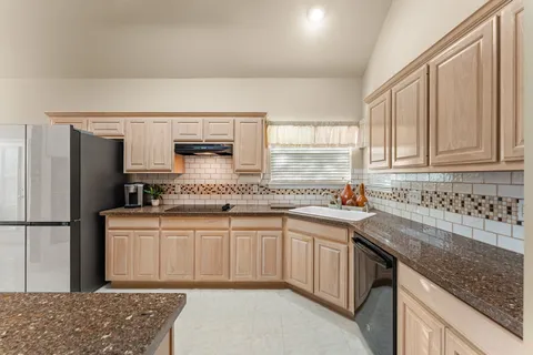 a kitchen with stainless steel appliances granite countertop a sink stove and cabinets